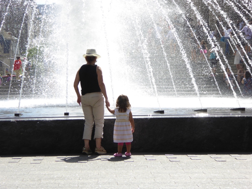 Little girl was enthralled by the fountain.